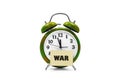 Camouflage color alarm clock with war word on notepad