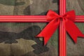 Camouflage-military texture with red ribbon Royalty Free Stock Photo
