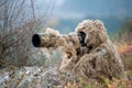 Wildlife photographer in the ghillie suit working Royalty Free Stock Photo