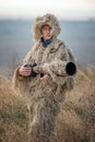 Wildlife photographer in the ghillie suit working Royalty Free Stock Photo