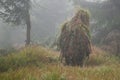 Camouflaged sniper in foggy forest Royalty Free Stock Photo