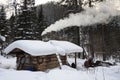 Camp of a commercial hunter in the Siberian taiga in the winter evening