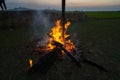 Camp fire from dry tree trunk at sunset. Royalty Free Stock Photo