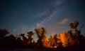 camp fire on night forest glade under starry sky Royalty Free Stock Photo