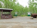 Camp ground firewood shed garbage bin outhouse Royalty Free Stock Photo