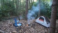 Camp kettle in the Blue Ridge Mountains in Asheville, North Carolina. Outdoor lifestyle with axe, cast iron skillet, flannel blan Royalty Free Stock Photo