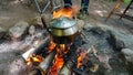 Camp kettle in the Blue Ridge Mountains in Asheville, North Carolina. Outdoor lifestyle with axe, cast iron skillet, flannel blan Royalty Free Stock Photo