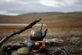 Camp kettle is heated on a bonfire. Hiking, travel in the mountains. Outdoor recreation concept. Lapland.