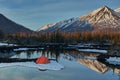 Camp near the mountain lake. Landscape with a tent near the water. Royalty Free Stock Photo