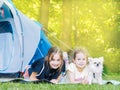 Camp in the tent - girls with little dog chihuahua sitting together near the tent. Camping with children Royalty Free Stock Photo