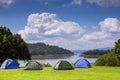 Camp and tent on green grass field under clear sky Royalty Free Stock Photo