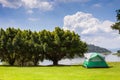 Camp and tent on green grass field under clear sky Royalty Free Stock Photo