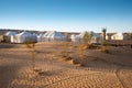 Camp of tents in a beautiful landscape of sand dunes in the desert of Sahara Royalty Free Stock Photo