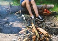 Camp tradition. Marshmallows on stick with bonfire and smoke on background. Holding marshmallow on stick. Roasty, toasty Royalty Free Stock Photo