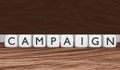 Campaign word on white cubes in black letters on a mocha mousse background. 3d rendering Royalty Free Stock Photo