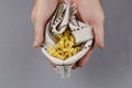 Campanelle, Gigli or ballerina pasta. Dry uncooked pasta in male hands against a gray background. A portion of Campanelle in a Royalty Free Stock Photo