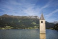 Campanile di curon venosta vecchia or Submerged tower of reschensee church deep in Resias Lake at morning in Trentino-Alto valley Royalty Free Stock Photo