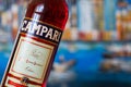 Bottle of Campari with background of cityscape, an alcoholic liqueur containing herbs and fruit, invented in 1860 in Novara, Italy Royalty Free Stock Photo