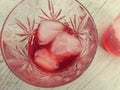 Campari served in two crystal glass with ice cubes