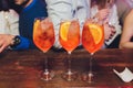 Campari tonic alcoholic cocktail with red bitter, tonic, lime and ice. Old wooden table background, bar tools, selective Royalty Free Stock Photo