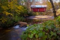 Covered bridge in Greer, South Carolina, USA with fall foliage and smooth water in stream Royalty Free Stock Photo