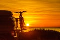 Camper with bicycles on rack camping on beach at sunrise