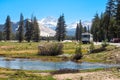 Camper caravan parked amidst Sierra Nevada mountain range in Yosemite National Park, California, USA. Vast landscape