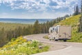 Camper Driving Down Road in The Beautiful Countryside Among Pine