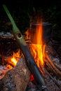 Camper fire cooking by field pot and boil water by green bamboo