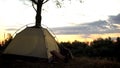 Camper resting in tent early in picturesque place, overnight in wild, sunrise