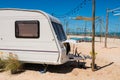 Camper RV car on white beach in summer at Cha-Am