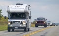 A camper RV trailer at a busy highway during a long weekend with lots of traffic