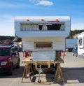 A camper supported by sawhorses in the walmart parking lot at whhitehorse