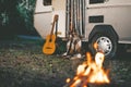 Camper van with gitar and fire place parking in forest at night