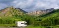 Camper van in the mountains, the Alps, Piedmont, Italy. Sunset dramatic sky and clouds, unique highlands and rocky mountains