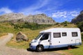 Camper van in mountains blue sky Royalty Free Stock Photo