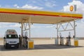 Apollo camper van at a Shell gas station in the Outback, Australia