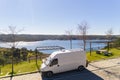 Camper van with solar panel drone aerial view in Odeleite dam reservoir landscape living van life on the countryside in Alentejo,