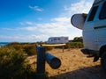 Camper van with surf board on beach Royalty Free Stock Photo