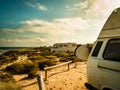 Camper van with surf board on beach Royalty Free Stock Photo