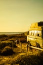 Camper van with surf board on beach Royalty Free Stock Photo