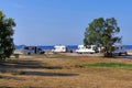 Camper vans parked near the pristine beach of Tristinika in the Chalkidiki peninsula, Greece