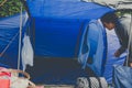 Campers set up a nylon tent