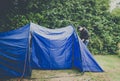 Guy adventurer pitching tent