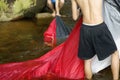 Campers washing tent in river