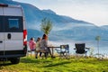 Campervan, Motorhome RV parked next to the lake or river in Bosnia and Herzegovina. Family with camper van or motor home eating Royalty Free Stock Photo