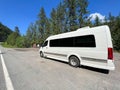 A campervan parked along the Kootenay River near Libby, MT on a bright sunny day in May