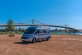 Campervan parked Ebro River bridge, Ebro delta, Catalonia, Spain in the sunshine