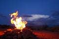 Campfire in front of desert storm Royalty Free Stock Photo