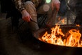 Campfire burning in a firepit . People sitting around. Camping life. Outdoor recreation